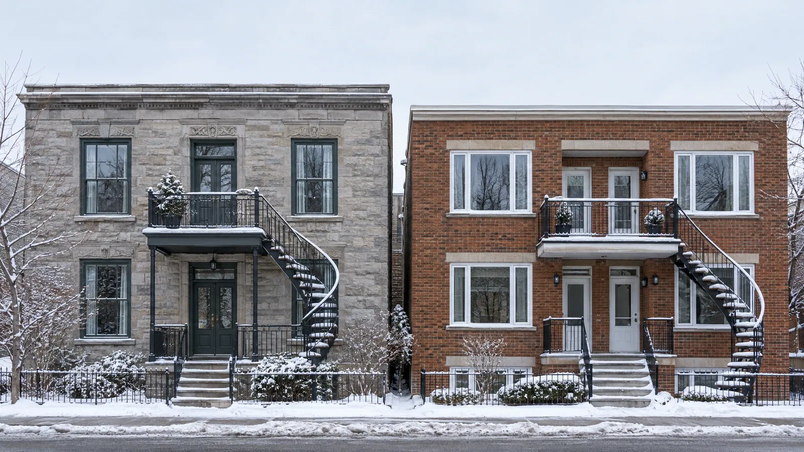 Greystone plex with dark wood guillotine windows beside a red-brick duplex with white casements, on a snowy street